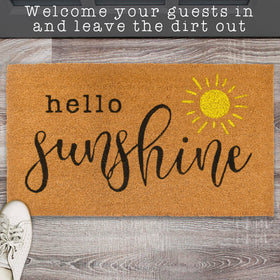MAINEVENT Hello Sunshine front door mat shown beside seasonal plants and welcome sign.