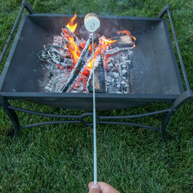 MalloMe camping setup with long roasting sticks and campfire