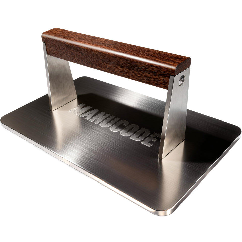 Manucode bacon press with flat bottom for even searing on a griddle