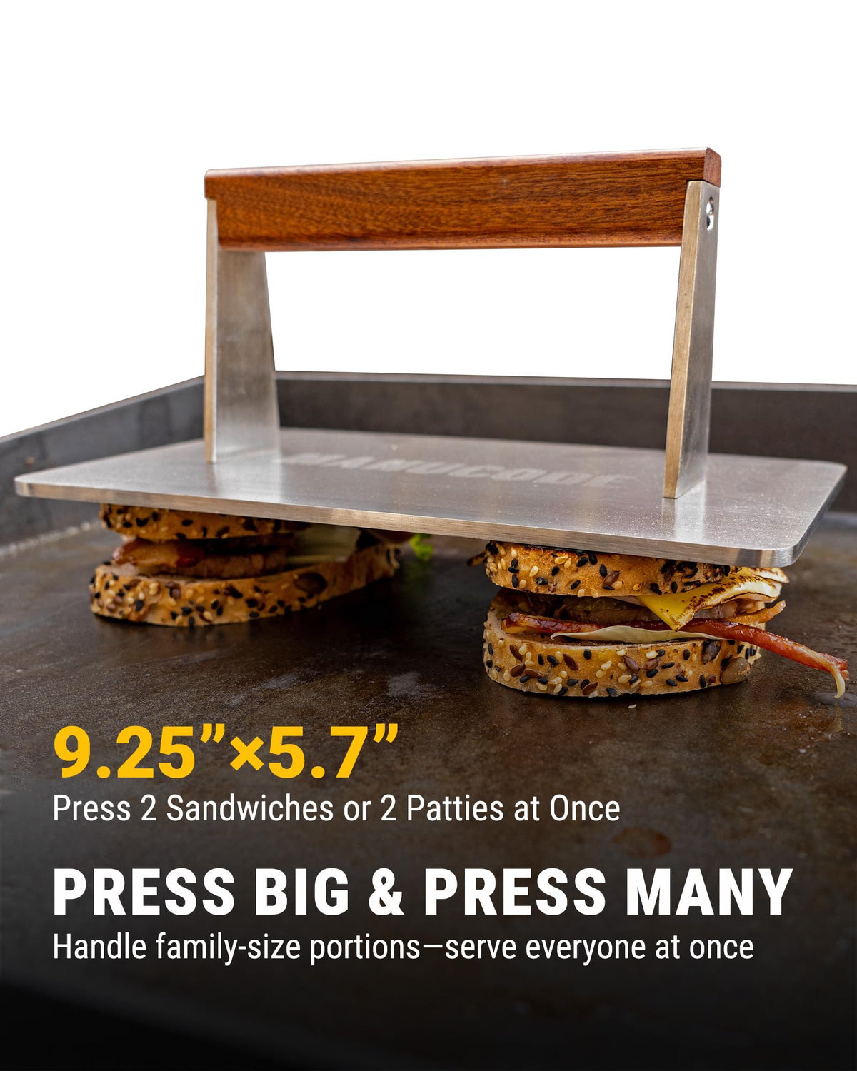 Manucode bacon press in use on a hot griddle with burgers