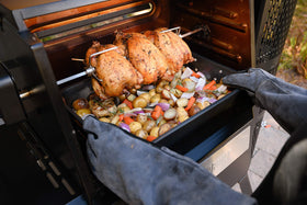 Masterbuilt Gravity kit attached on a grill demonstrates hands-free roasting.