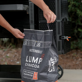 Masterbuilt gravity-series grill setup using lump charcoal for precise temperature control.