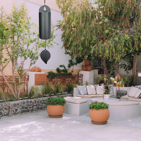 MEDOO Black steel wind chime enhances garden decor with subtle breeze.