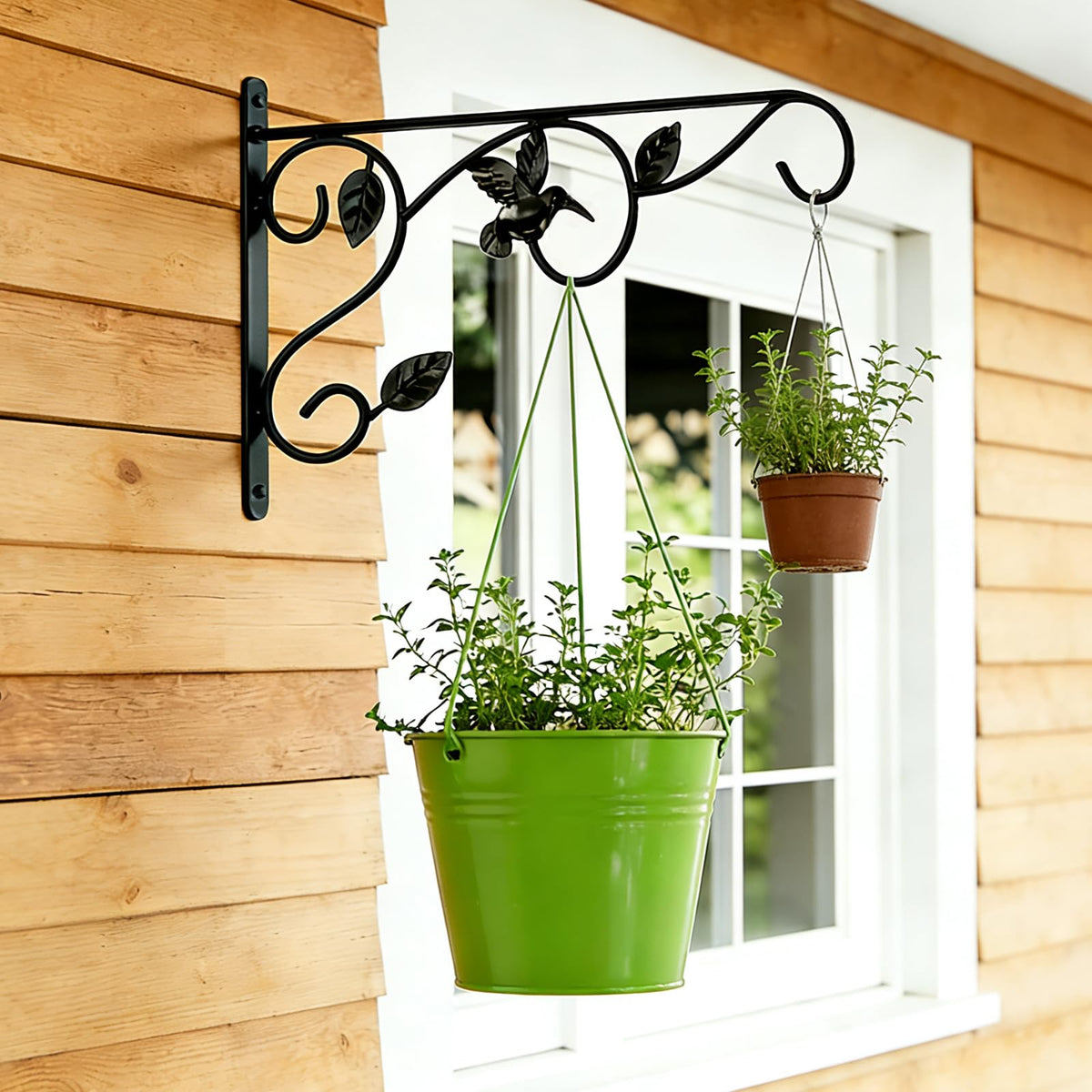 Mekpiwu wall hook holding bird feeder in a garden setting.