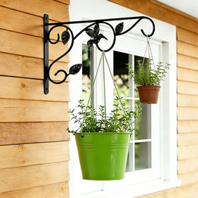 Mekpiwu wall hook holding bird feeder in a garden setting.