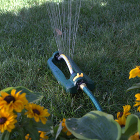 Overspray adjustment tabs helping limit waste near driveways