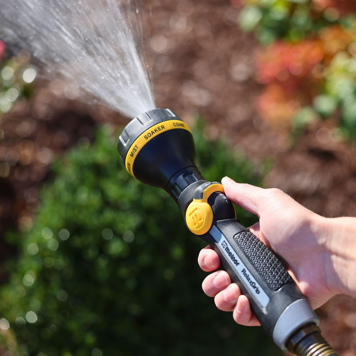 Melnor RelaxGrip garden-use nozzle in action on plants and paths