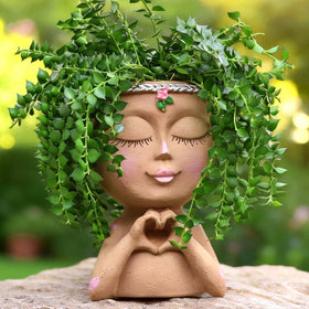 Meltset M Face Planter with Heart Hands front view adds personality to indoor decor.