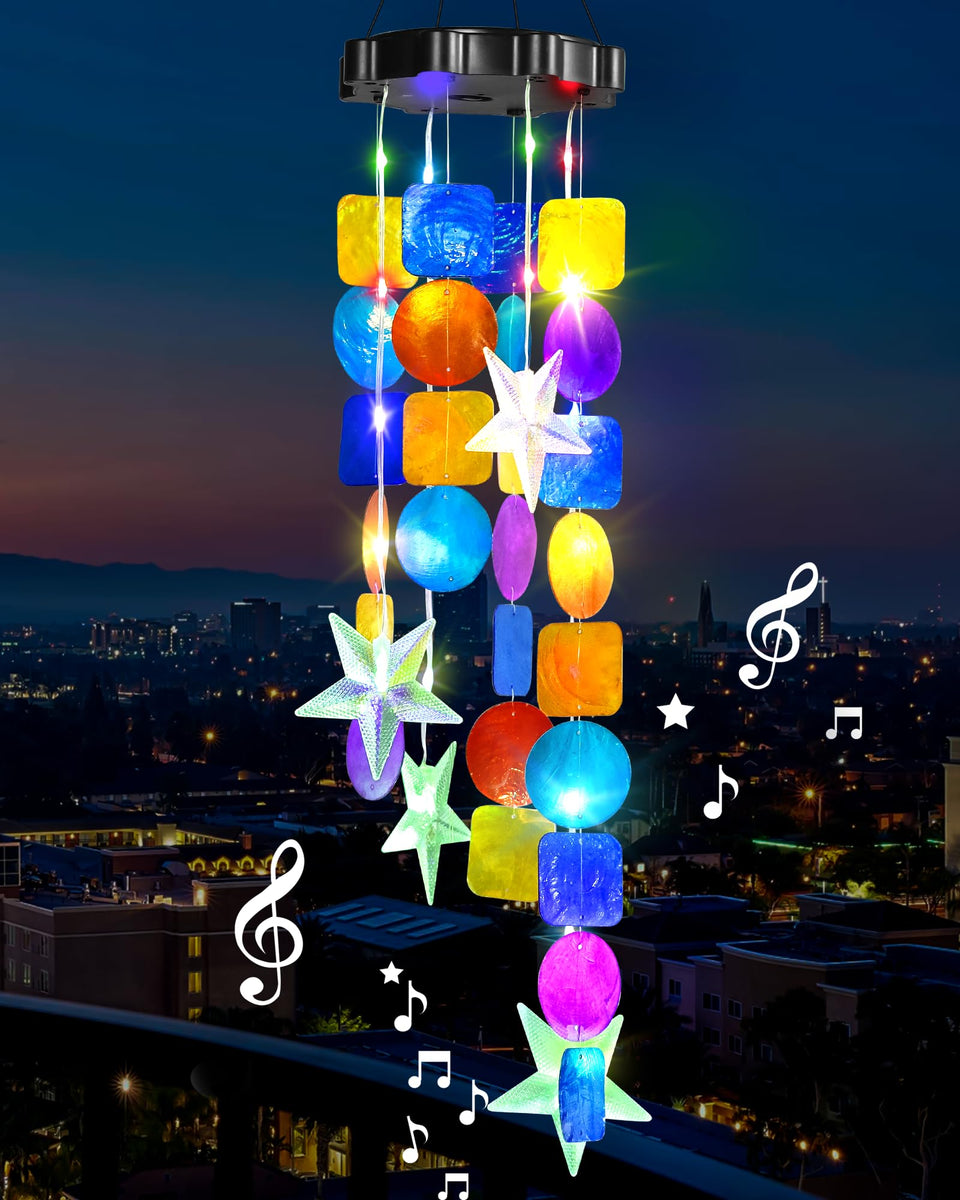 MERRIMAX M solar shell wind chimes illuminate garden at dusk for inviting outdoor ambiance.