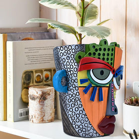 Midogaigai abstract face pot suited for indoor and outdoor decor.