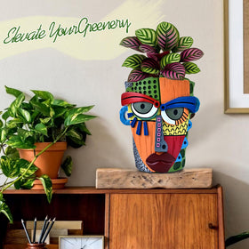 Midogaigai abstract face pot large size serves as a striking focal point.