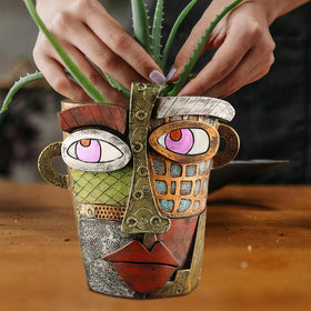 Midogaigai colorful abstract face pot brightens spaces with playful design.
