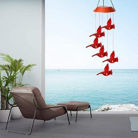 Milcraft Solar Cardinal Wind Chime illuminated at night with color-changing LEDs