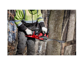Milwaukee chain in action cutting with saw and visible chips.