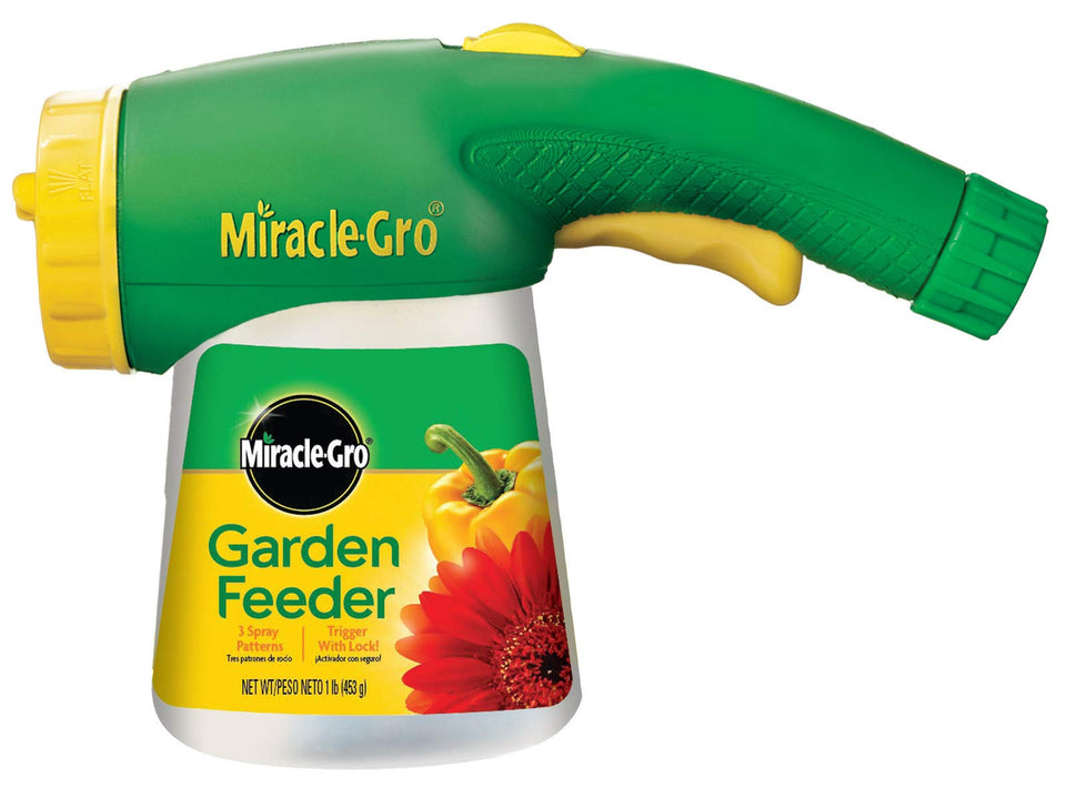 Miracle-Gro Garden Feeder attached to hose for easy outdoor feeding.