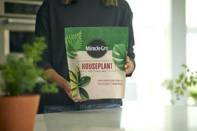 Miracle-Gro Houseplant Potting Mix detail, featuring peat moss and coir components