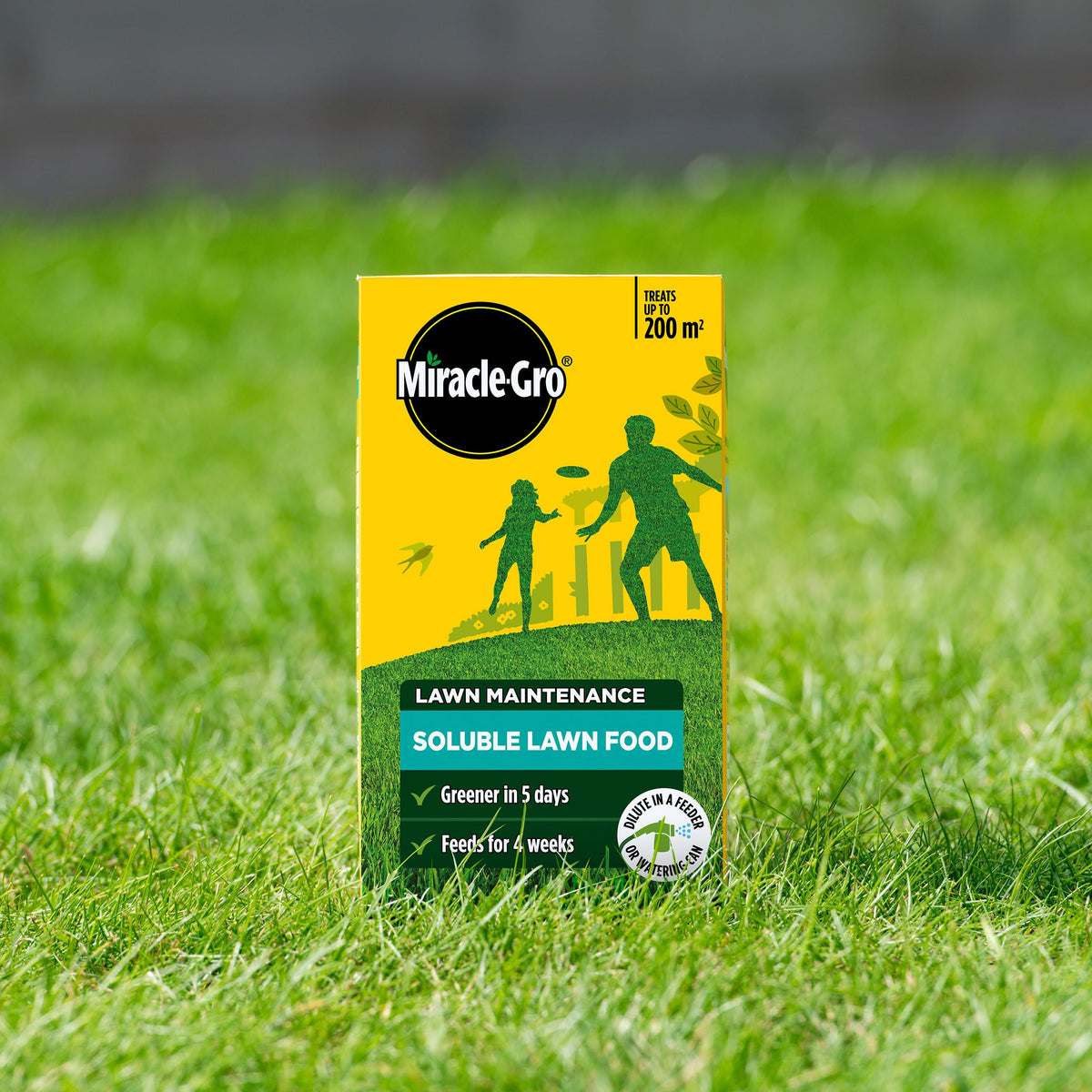 Miracle-Gro Lawn Food being poured with a watering can for simple, even coverage.