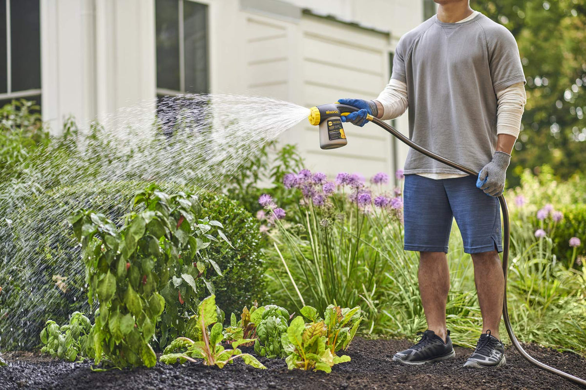 Hose sprayer attachment enables simple feeding while watering outdoor beds.