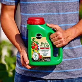 Miracle-Gro Shake 'N Feed applied to in-ground tomato and vegetable beds.
