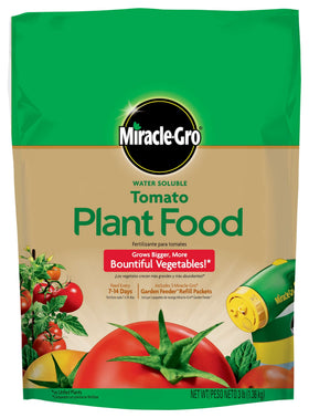 Miracle-Gro Tomato Food pouring into a watering can for quick feeding.