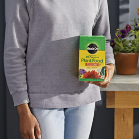 Miracle-Gro dissolving in water for even outdoor feeding.