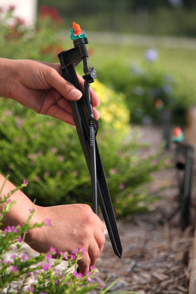 Mister Landscaper stake with on/off valve and flow controller for adjustable irrigation.