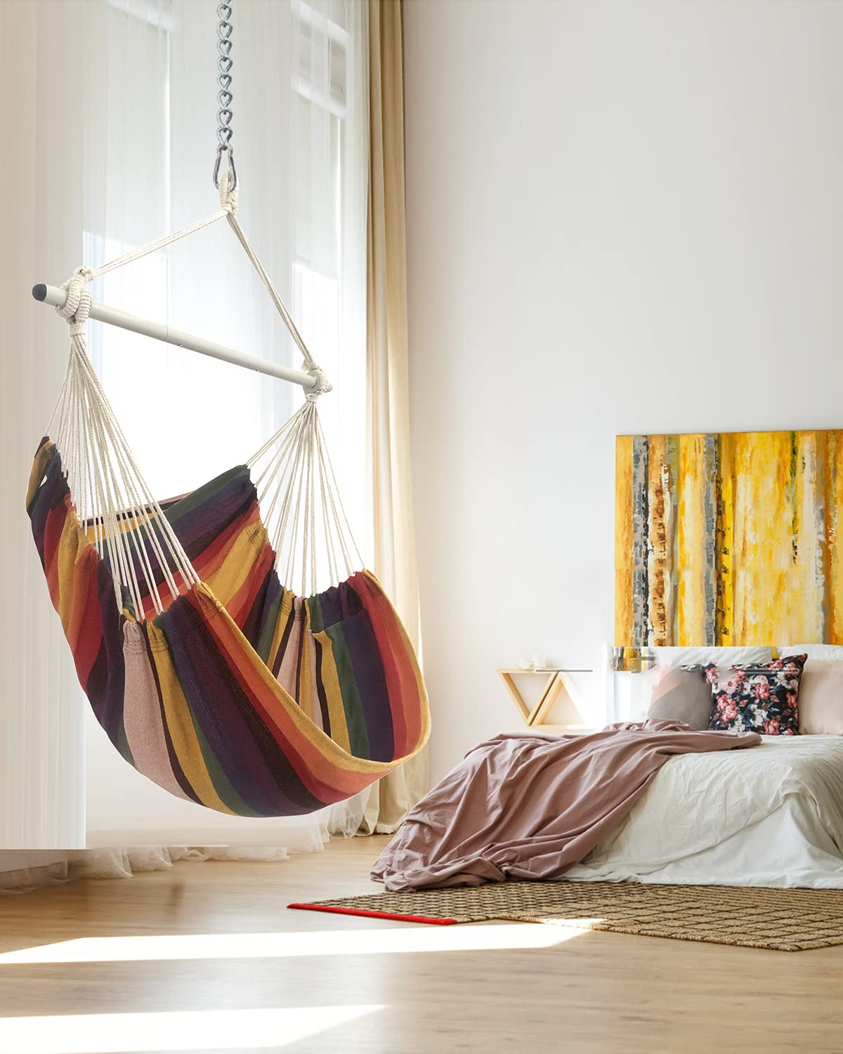 MIZTLI hammock chair installed in a cozy bedroom creates a relaxing corner.