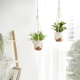 Mkono four-strand macrame hanger supports planter with boho style