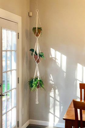 Mkono 70-inch indoor/outdoor plant hanger beside a window