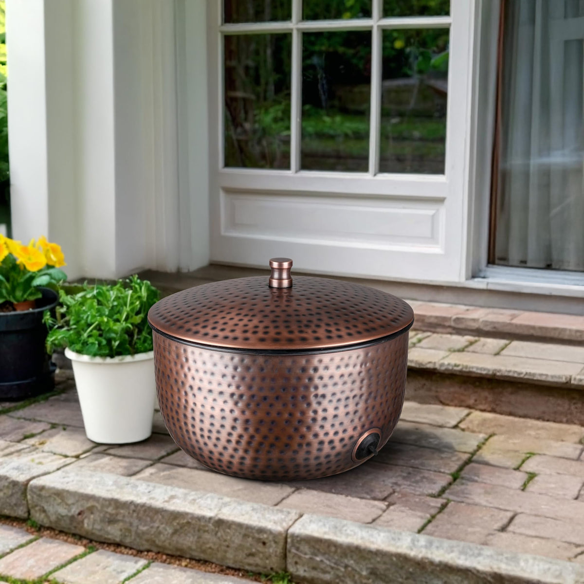 Monarch Abode hand-hammered metal hose holder for durable outdoor use.