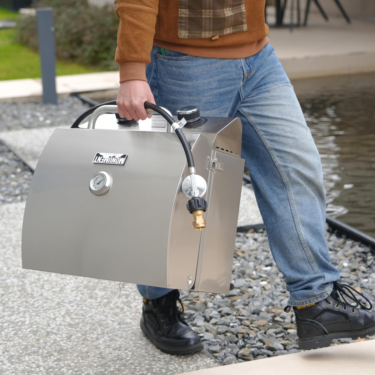 Monument Grills travel locks secure lid during transport for portable camping meals.