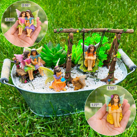 Mood Lab miniature fairy figures on swing enhance indoor shelf decor.
