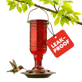 More Birds Red Jewel bottle closeup highlighting vivid glass and vintage charm.
