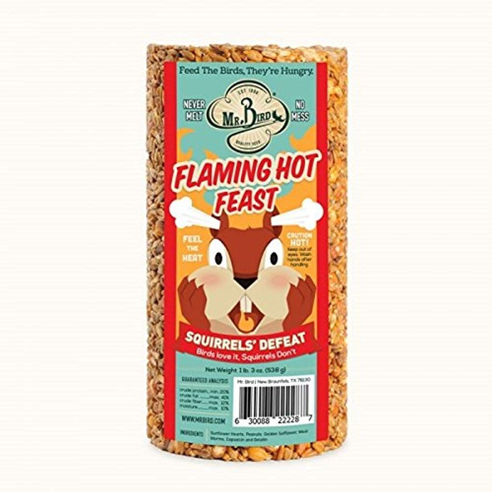Close-up of Mr. Bird Flaming Hot Feast cylinder showing seed mix for quick bird attraction.
