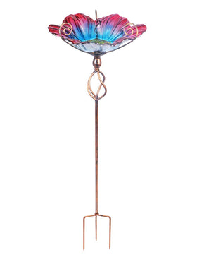 Colorful glass bowl with a scalloped edge attracts birds to your garden.