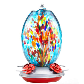 Muse Garden glass hummingbird feeder in blue fireworks design attracts garden visitors.