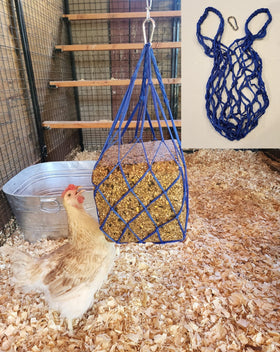 Muzzys blue chicken coop treat bag hanging in coop, keeping treats clean and off the ground.