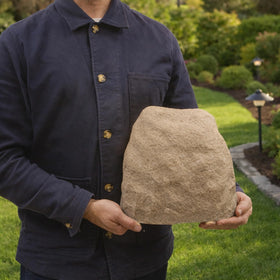 Naturalings heavy-duty fiberglass rock cover withstands outdoor conditions while guarding sprinkler valves.