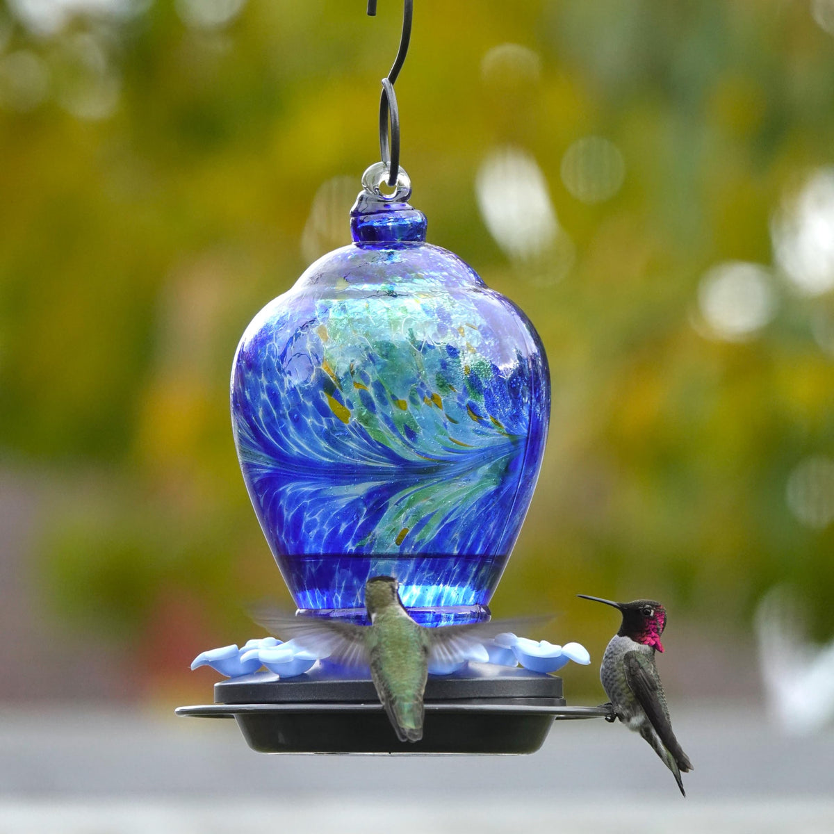 Premium hand blown feeder serves as a decorative centerpiece in outdoor spaces.