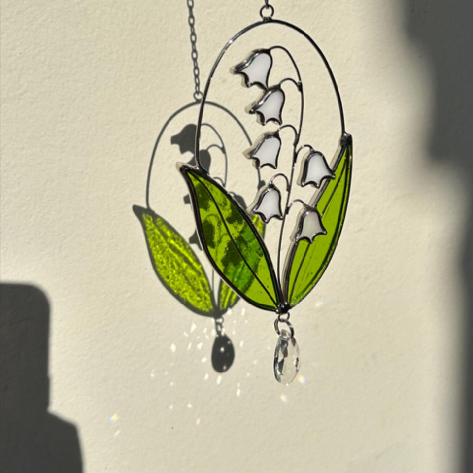NEONGRAND Lily of the Valley suncatcher in sunlight brightens windows with colorful glass.