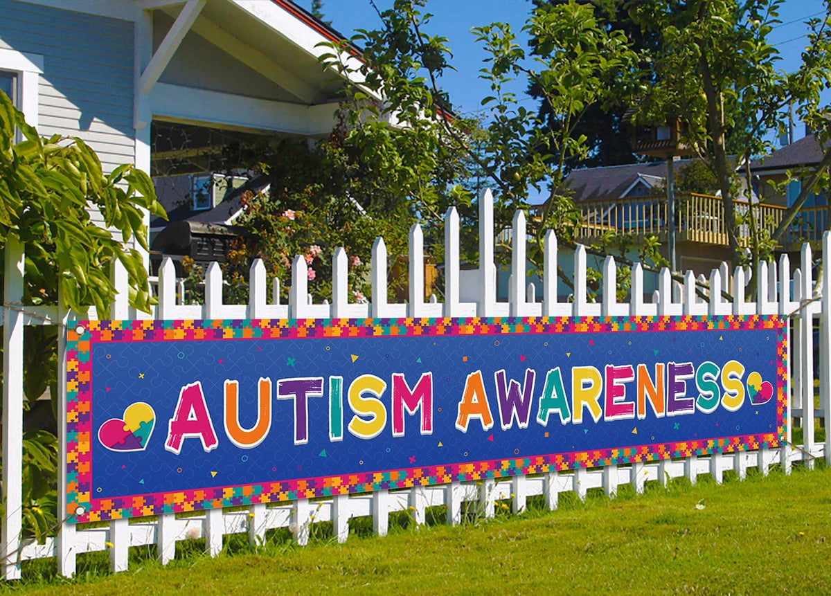 Nepnuser autism banner puzzle piece for outdoor display on a fence.