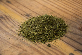 New Country Organics alfalfa meal pellets closeup highlights the golden, protein-rich texture.