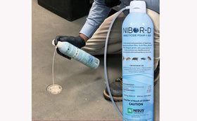Nisus Nibor-D foam with hose attachment for precise application.