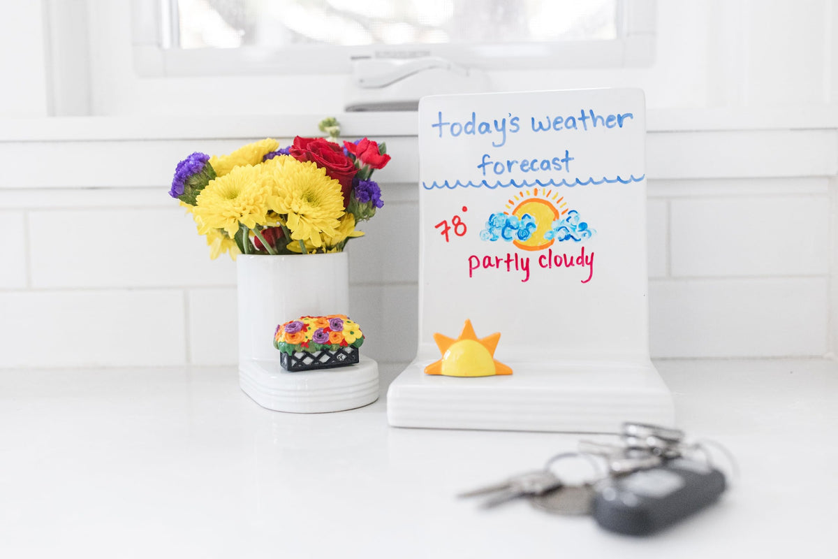 Nora Fleming Love Blooms Here hand-painted mini adds spring charm to tabletops.