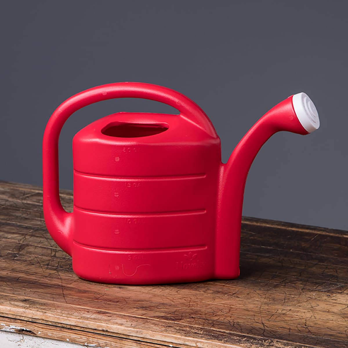 Novelty Root & Vessel 30411 red watering can close-up of measurement marks for accurate irrigation.