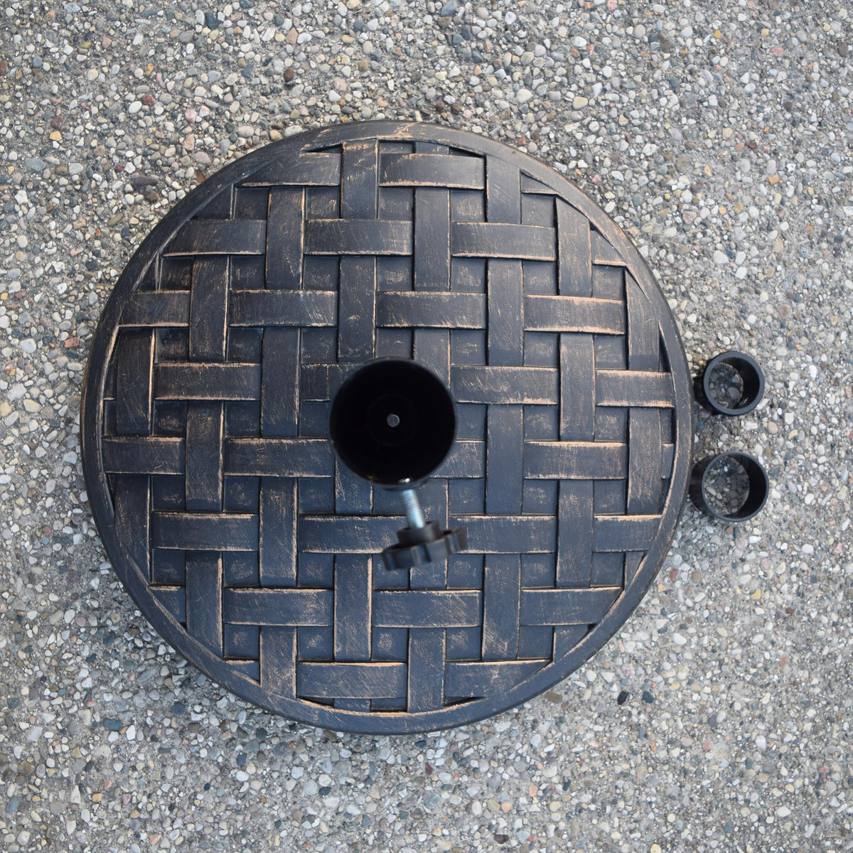 Oakland Living outdoor base in use with umbrella demonstrating secure tension screw
