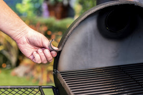 Oklahoma Joe's gasket being installed on a smoker for enhanced chamber seal.