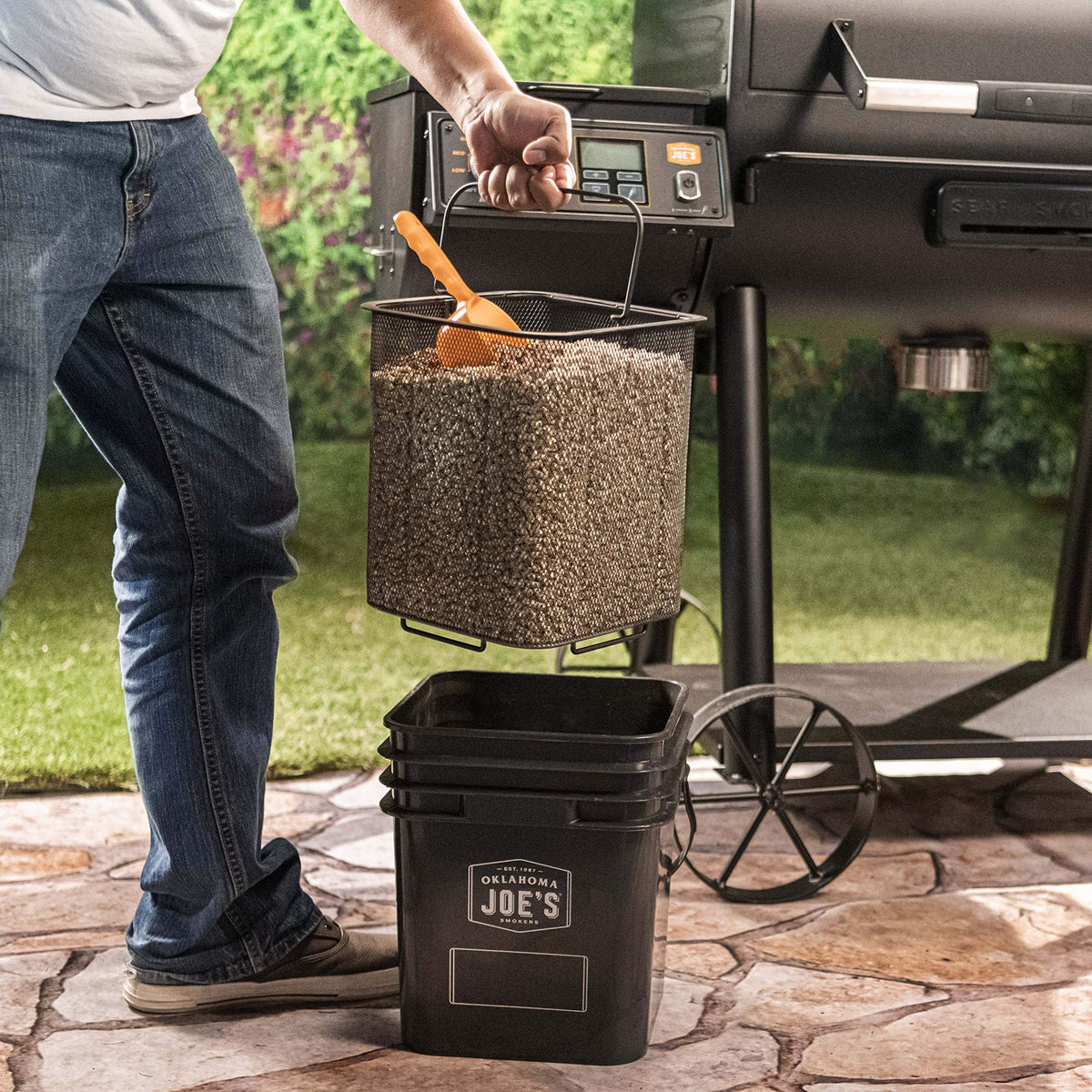 Oklahoma Joe's black pellet bucket kit ready for grilling and refueling.