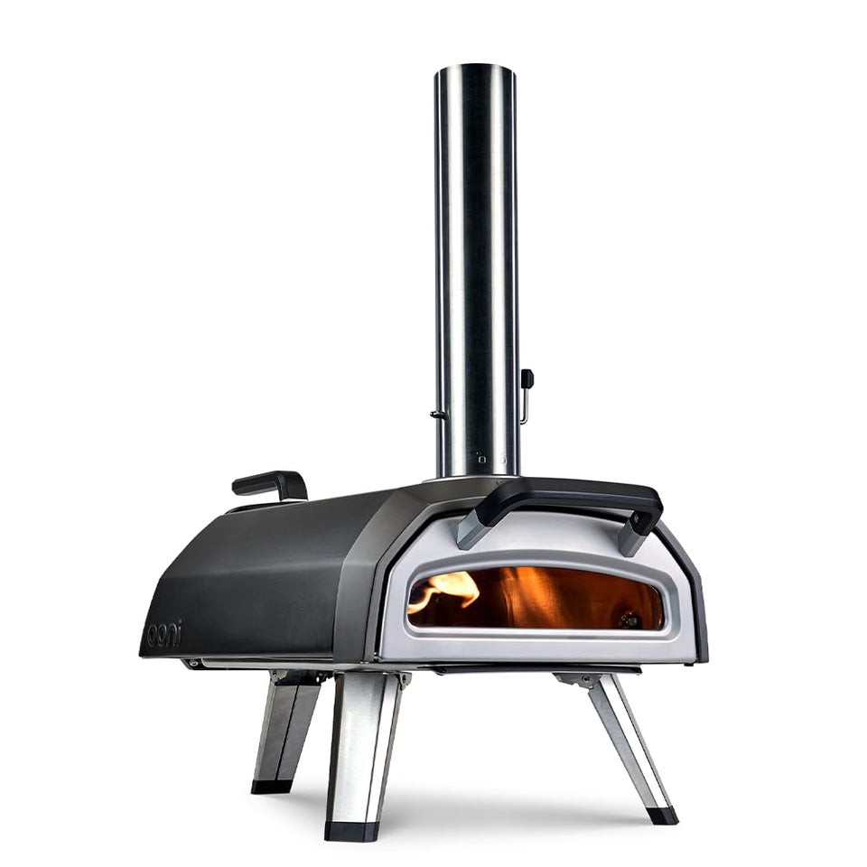 Ooni Karu 2 multi-fuel oven set up for wood-fire cooking outdoors.