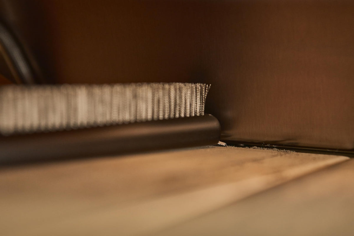 Ooni cleaning tool shown with stone and oven in use.